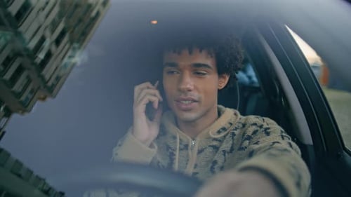 Young Adult Talking on Cell Phone While Driving