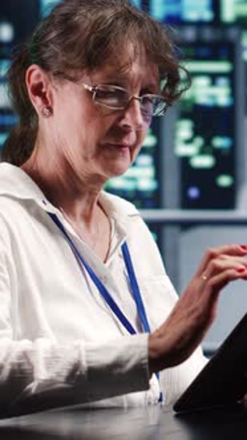 Woman Works on Tablet with Code Displayed