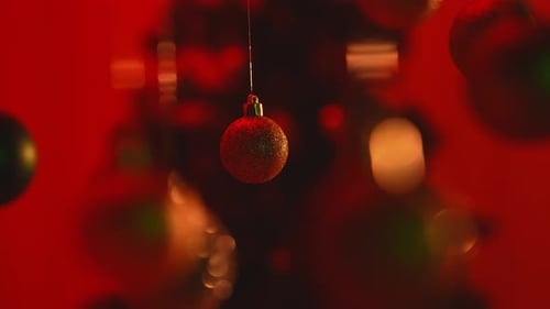 Christmas Tree Golden Green Balls Highlighted By Red Light Hanging From Top Glittering Ornaments