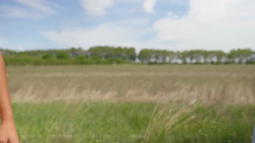 People Shaking Hands in Rural Field