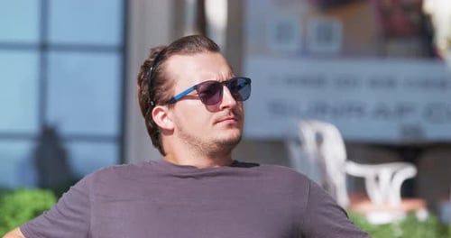 Man Sitting Outdoors on a Sunny Day