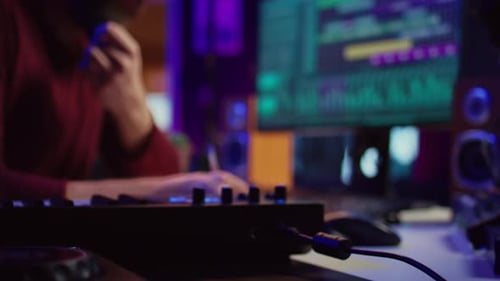 Music Producer Working in Recording Studio at Night