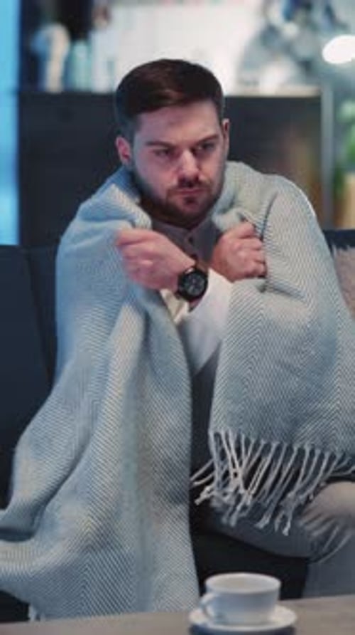Caucasian Young Sick Adult Wearing Covering in Warm Blanket Recovering Illness Suffering Virus of