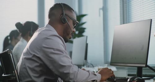 Man Works At Computer In Bright Office