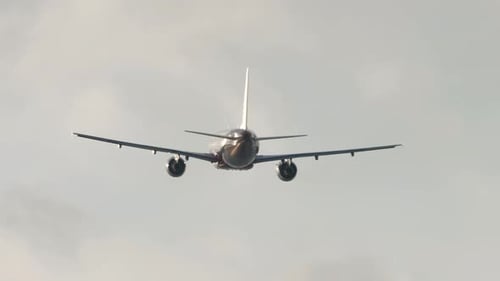 Passenger Jet Ascending Into Overcast Cloudy Sky