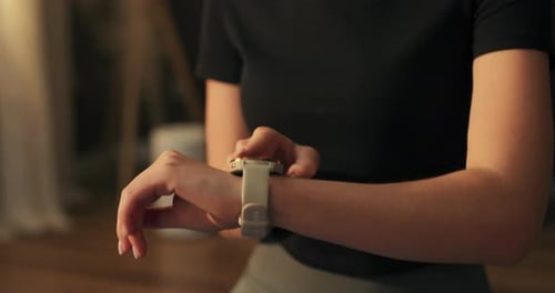 The Woman Checks Her Heart Rate Training Progress After Exercises Done at Home on the Watch