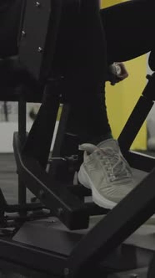 Woman exercising legs at an indoor gym