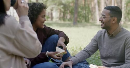 Friends Enjoying a Picnic Together in Park