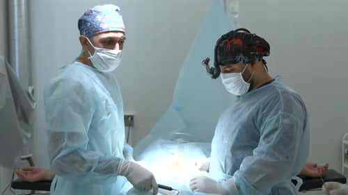 Surgeons Operating on Patient in Hospital Operating Room