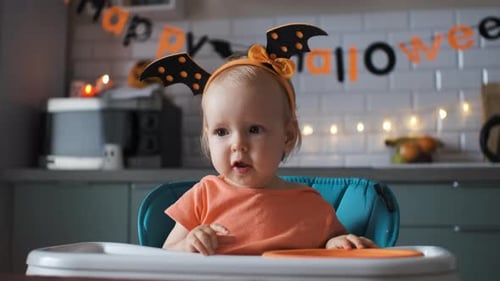 Adorable Infant Celebrates Halloween in High Chair
