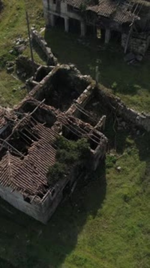 Fly above abandoned houses vertical video