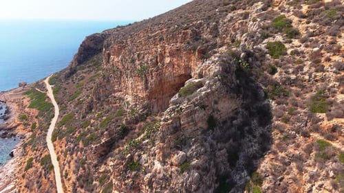 Breathtaking Aerial View of Rugged Sicilian Coastline and Cliffside