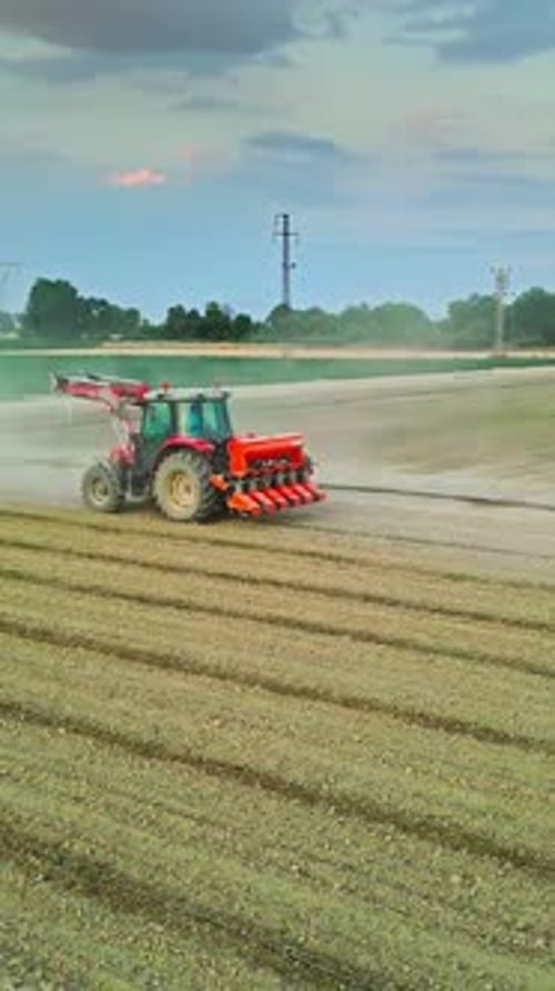 Tractor Working in a Field Surrounded by Farmlands - Aerial View
