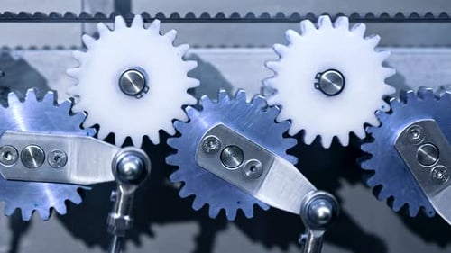 Closeup of Steel Gears Spinning Inside Complex Engine Mechanism