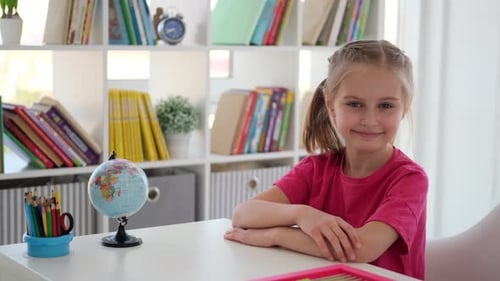 Primary School Girl Sitting at Desk