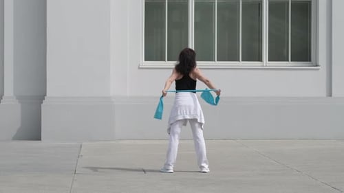 Woman Doing Arm Stretches with Resistance Band