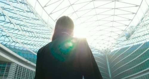 Woman Celebrating Success in Modern Architecture