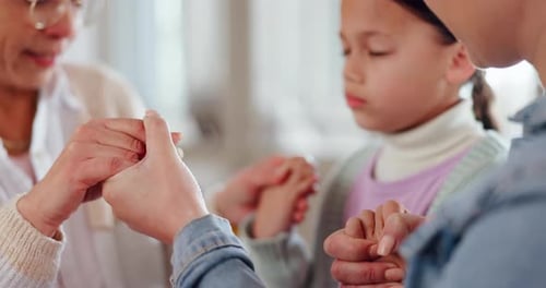 Family, woman and children holding hands for prayer, worship or trust in God with closeup in home
