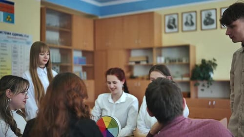 High School Seniors Join Hands in Class As a Sign of Working Together