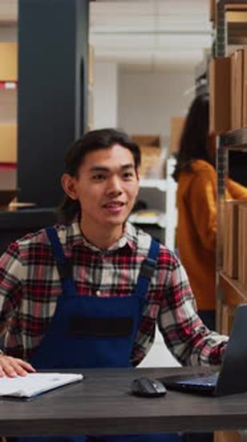 Young Adult on Video Call in Warehouse