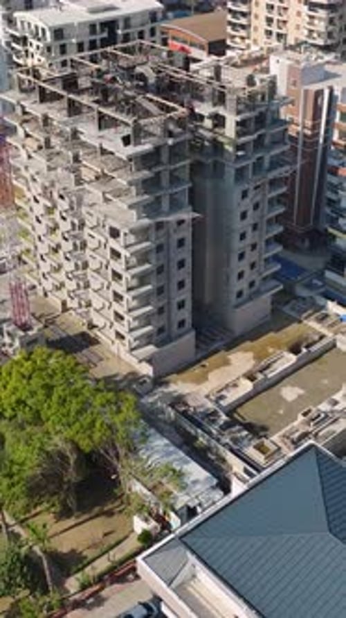 Vertical Video of Crane Holding Wall Modules While Crew Installs Them