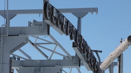 Cable Car Wheels Atop of a Tower with Blue Sky Background, Close Up.
