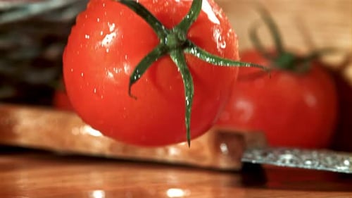A Tomato Falls on a Wet Cutting Board Filmed on a Highspeed Camera at 1000 Fps