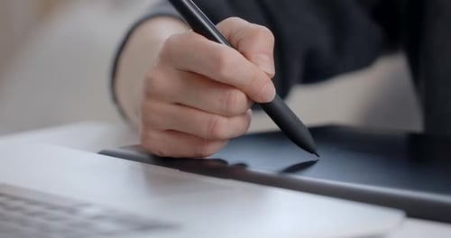 Hand Using Stylus on a Digital Tablet