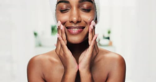Woman Applying Moisturizing Cream to Face