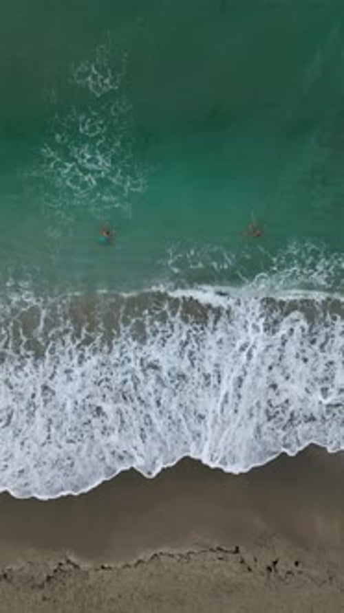 Vertical Video Coastal Sunrise Aerial Gaze Upon the Mediterranean Sea's Texture