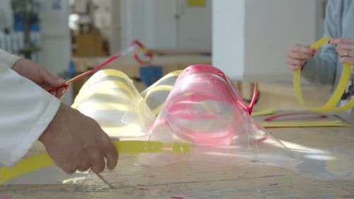 Workers Assembling Personal Protective Equipment in Bright Factory