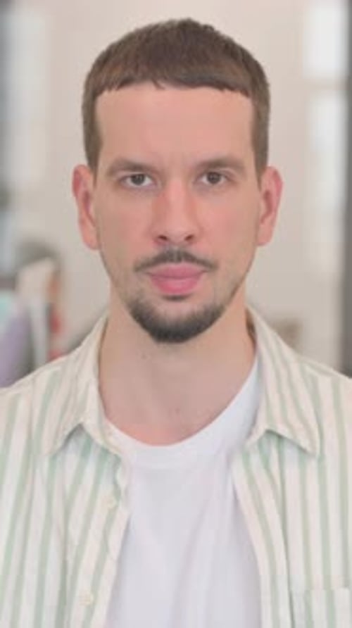 Close Up of a Man Indoors with White T-Shirt