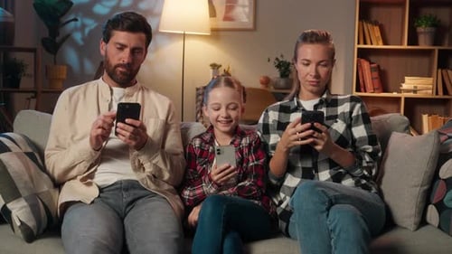 European Family Using Mobile Phones Smartphones Addiction Dependency Online Internet Gadgets at Home