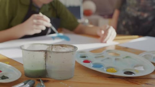 Children Painting Art Together at a Wooden Table