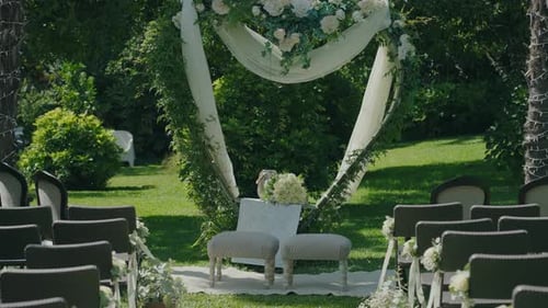 Elegant Wedding Ceremony Setting With Greenery and Flowers