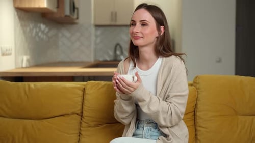 Woman Relaxing with a Mug on Couch at Home