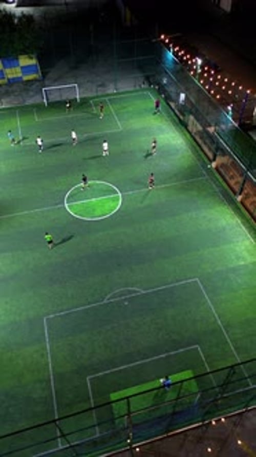 Vertical Drone Footage of mini football match, soccer. MiniFootball field and Footballers from drone