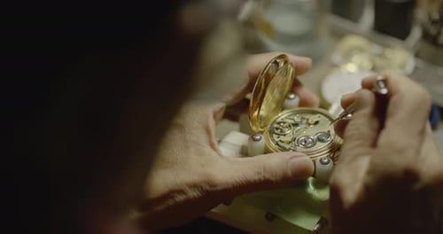 Watchmaker Repairing Intricate Gold Watch Mechanism Close Up