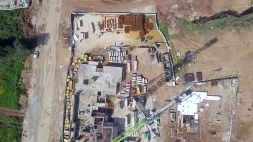 Large residential construction site with cranes, Aerial view