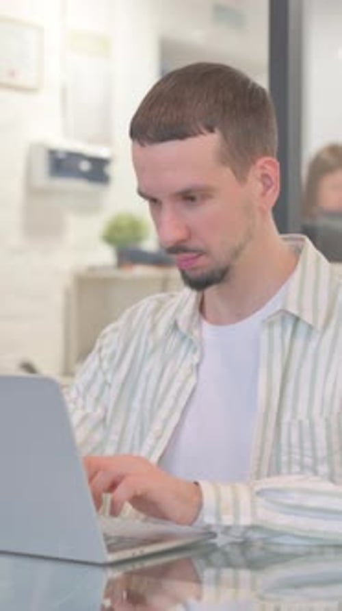 Creative Young Man with Thumbs Up while Working in Office, vertical video