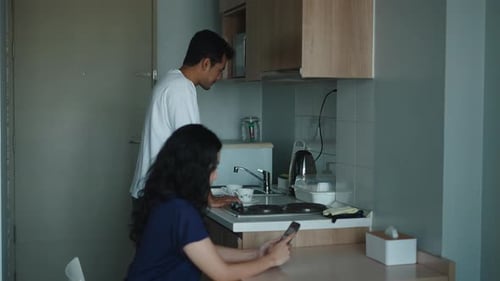 Couple in Apartment Kitchen with Sink and Counter