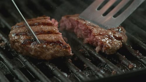 Closeup Shot Of Hamburgers Cooking On Grill, Slow Motion.