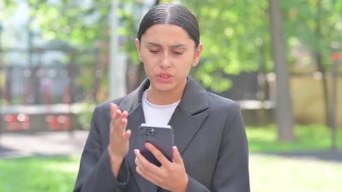 Portrait of Hispanic Business Woman Criticizing Online Loss Outdoor