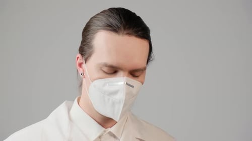 Health Professional Puts on Stethoscope and Looks at Camera