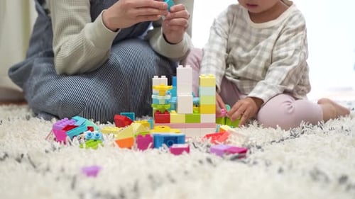Woman and Child Building Blocks at Home