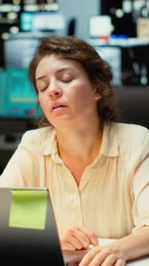 Woman working on laptop in modern office setting