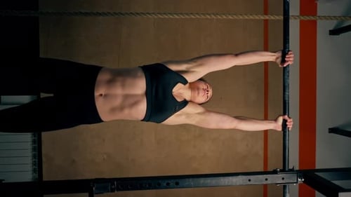 Vertical Video Low Shot in the Gym Coach Girl in Black Leggings and a Top Weighs on the Horizontal