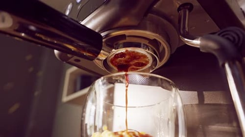 Slow Motion Close Up Of Espresso Machine Showing Incorrect Bottomless Portafilter Extraction With