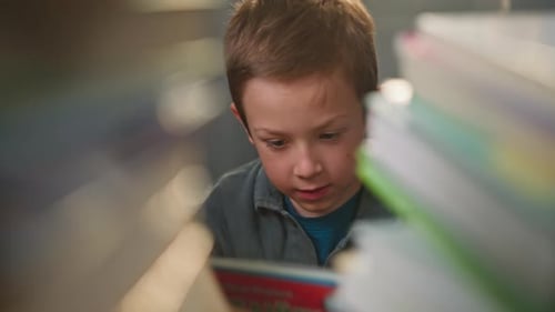 Young Boy Reading a Book at Home Preparing for School Study Learning