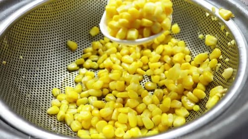 Sweet Corn Kernels in Silver Colander Close Up